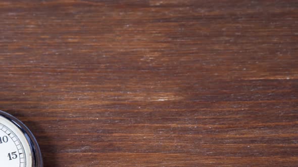 Old Chronometer Counts Time on Brown Wooden Background