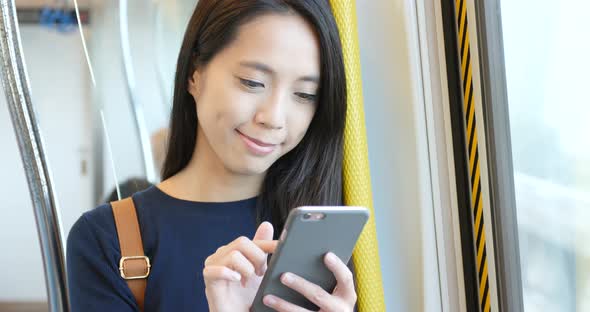 Travel Woman using cellphone in train compartment