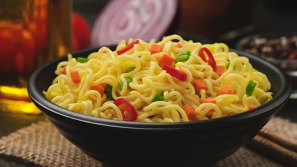 Instant noodles on black background, spicy asian lunch, ProRes uncompressed