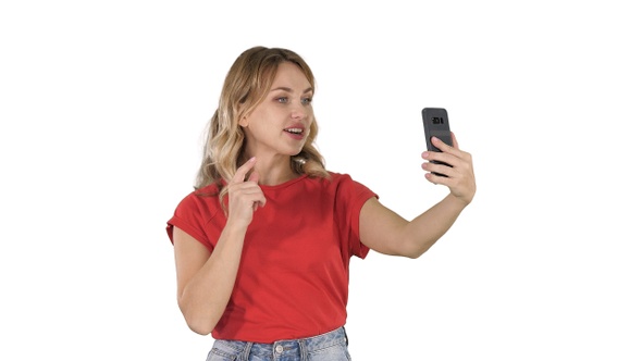 Cheerful female blogger recording video to front camera