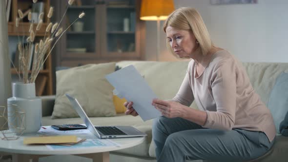 Woman Doing Financial Paperwork Indoors