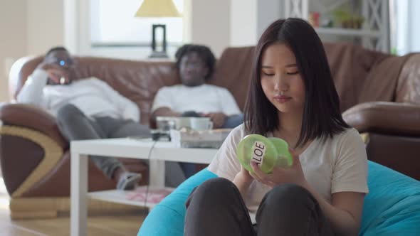 Slim Beautiful Asian Woman Opening Jar of Aloe Cream and Applying It on Face