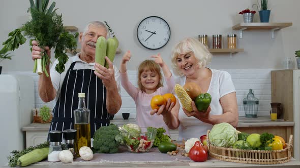 Girl with Mature Man and Woman Recommending Eating Raw Vegetable Food. Healthy Nutrition Diet