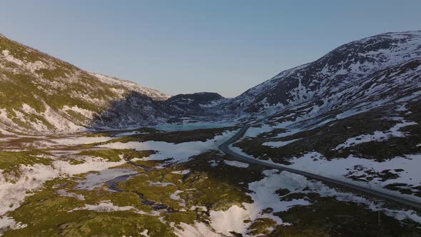 Aerial of lonely road. Snowy mountains. isolation. Solitude. Loneliness. Snow