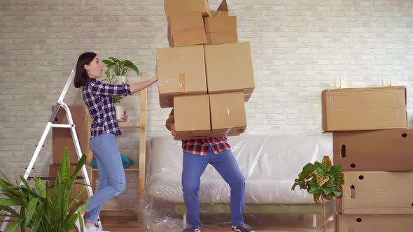 Fale Man Falls with Boxes Problems When Moving To a New Apartment