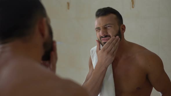 Handsome Male Applying Aftershave Lotion on Sensitive Skin, Itchy Irritation