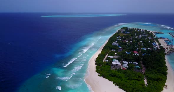 Natural birds eye travel shot of a sandy white paradise beach and aqua blue ocean background in best