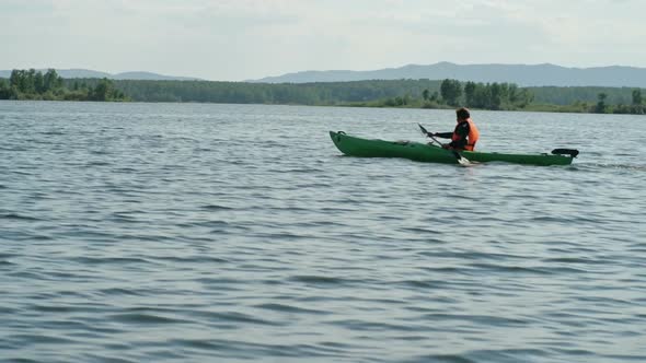 Man Exploring Lake with Kayak