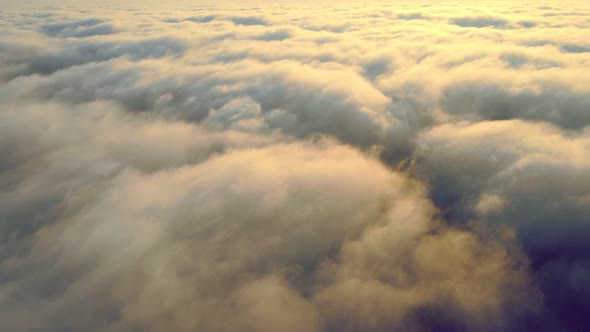 Fabulous Sunrise Over the Clouds. Flight Over the Morning Fog Above the Sky and Sunbeams That