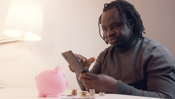 Man Using Phone to Check His Bank Account