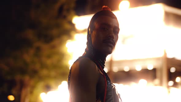 Man With Red Ponytail And Pvc Posing By Neon Lights