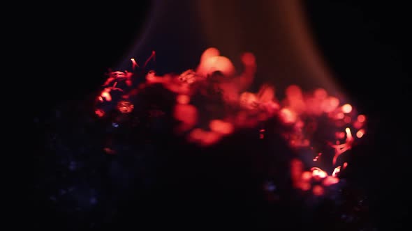 Fire burning on steel wool as it is spinning while floating.