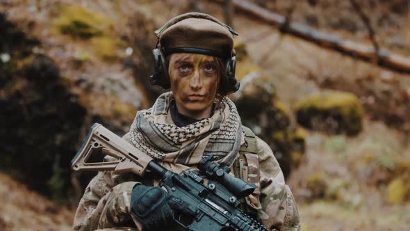 Armed Female Soldier Holding an Automatic Rifle Portrait Looking to the Camera  Army Career Concept