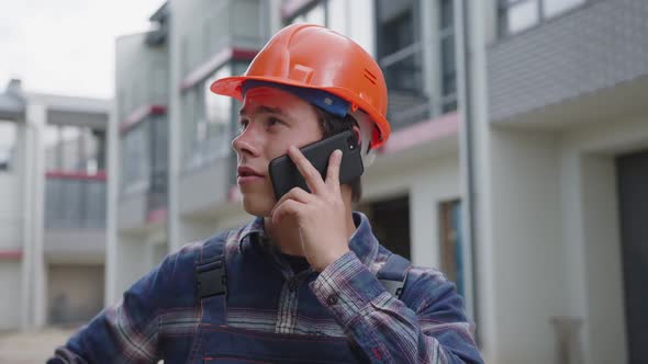 Close Up View of Young Builder with Black Phone