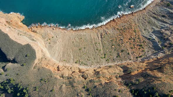 Aerial view of cliff on the beautiful coast of the Serra Gelada natural park. Alicante, Spain. Top d