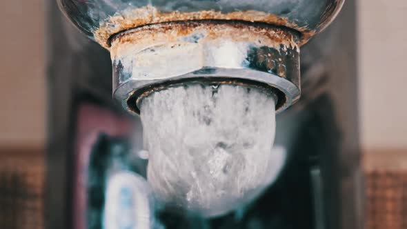 Faucet with Running Water in Slow Motion Macro Shot