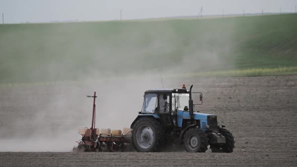 Tractor Plowing Field In Spring Season