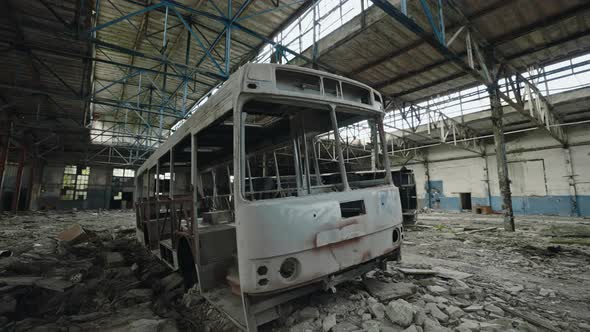 Destroyed Bus Standing Inside Ruined Factory During War