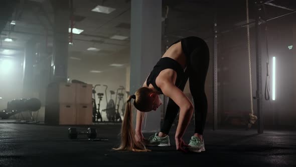 A Young Slender Woman Prepares and Warms Up Before Training