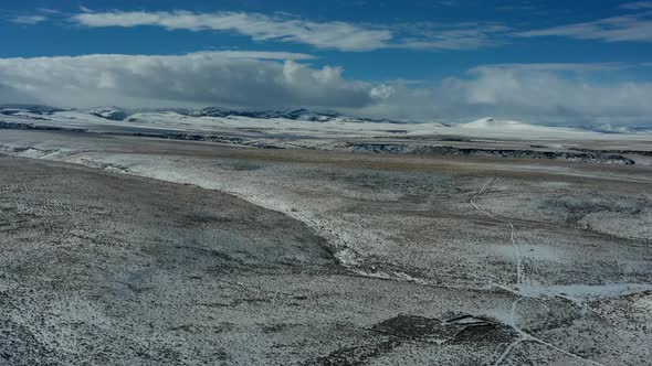 Time lapse drone shot of snowy plain