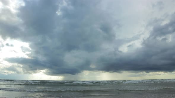 Time lapse of dramatic dark storm cloudsing fast over the Baltic sea at Liepaja towards the camera,