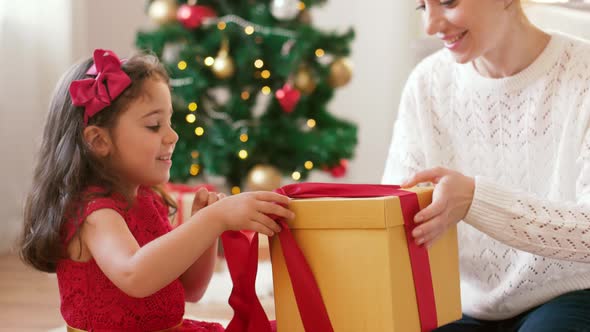 Mother and Daughter with Christmas Gift at Home 6