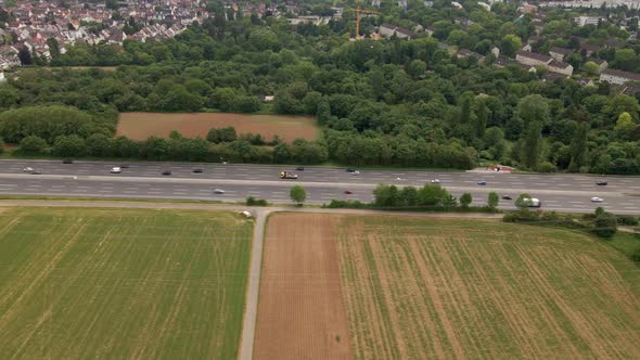 Afternoon traffic moving along the Highway a66 past Eschborn in Hesse, Germany. Aerial parallel foll