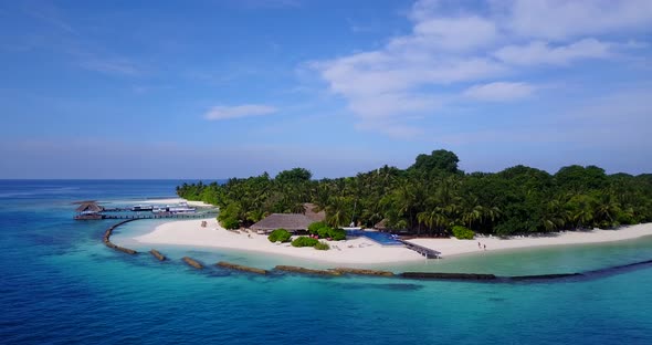 Tropical birds eye clean view of a sunshine white sandy paradise beach and aqua blue ocean backgroun