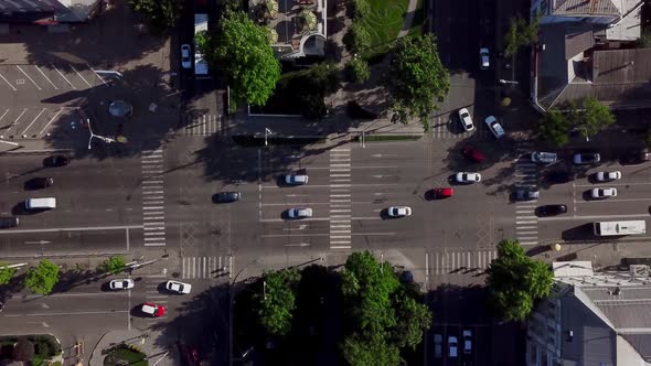 Drone's Eye View - Aerial View of the Vehicular Intersection, Fly Under Trees.