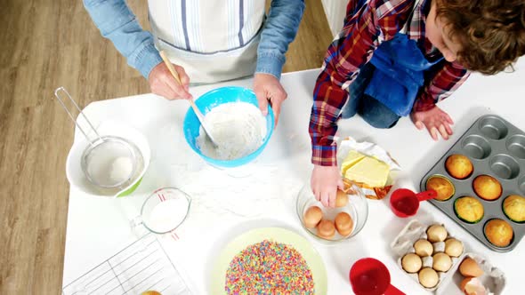 Father and son preparing cupcake