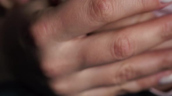 Baby Squeezes Mother's Hand with Small Fingers