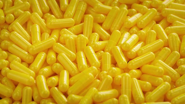 Pile Of Yellow Medical Capsules Rotating