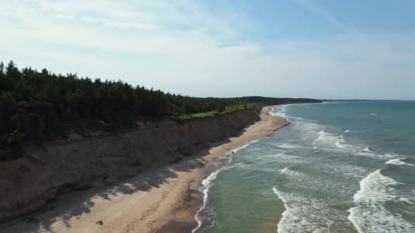 Fantastic Slow Motion Drone Forward Fligh Above Turquoise Baltic Sea with Waves and Sand Cliff