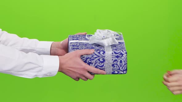 Gift. Man Gives a Girl the Blue with Ornament Box