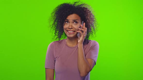 Young Emotional African American Woman Talks on Phone and Dances on Chromakey