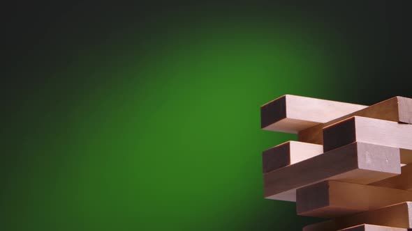 A Tower Made of Wooden Blocks on a Green Gradient Background