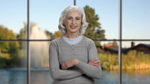 Smiling Mature Woman Gesturing Thumb Up.