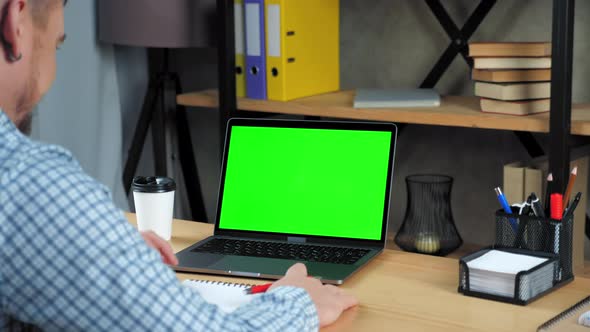 Green screen laptop concept: Laughing businessman tells online video call chat