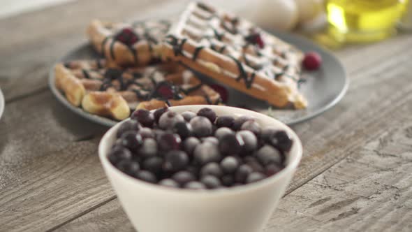 Dusting White Powdered Sugar Belgian Waffles Into The Cage.