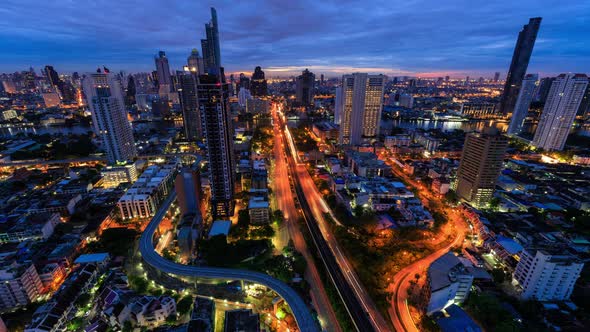 Bangkok business district city center above trident road and traffic, night to day - Time Lapse