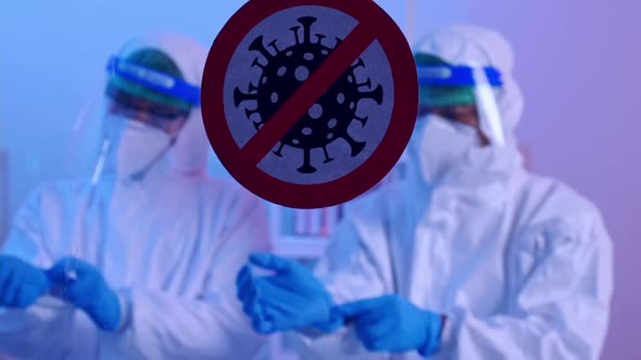 Group of scientists wearing personal protective equipment (PPE) in laboratory.