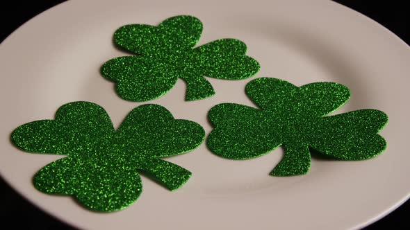 Rotating stock footage shot of St Patty's Day clovers on a white surface - ST PATTYS 007