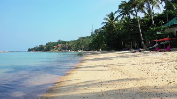 Daytime birds eye island view of a sandy white paradise beach and aqua blue ocean background in hi r