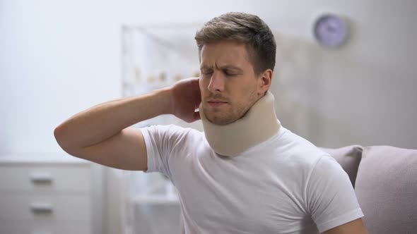 Displeased Man in Foam Cervical Collar Suddenly Feeling Pain in Neck, Trauma