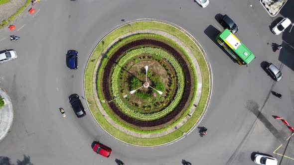 Traffic atmosphere at an intersection with a park circle in the middle in Yogyakarta, Indonesia