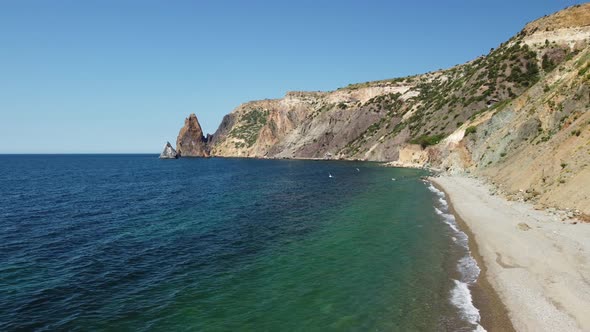 Aerial View From Above on Calm Azure Sea and Volcanic Rocky Shores