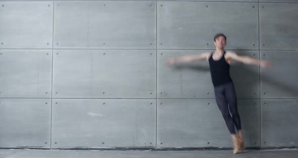 Elegant Male, Ballet Dancer Performs Acrobatic Elements of a Ballet Dance on a Gray Background, Slow