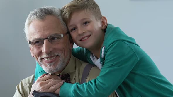 Happy Retired Man Hugging With Grandchild, Enjoying Free Time Together, Family