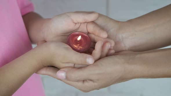 Burning Candle in the Hands