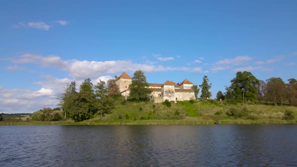 Aerial Drone Shot of Historic Castle on Hill Near Lake Medieval Architecture and Cultural Landmark